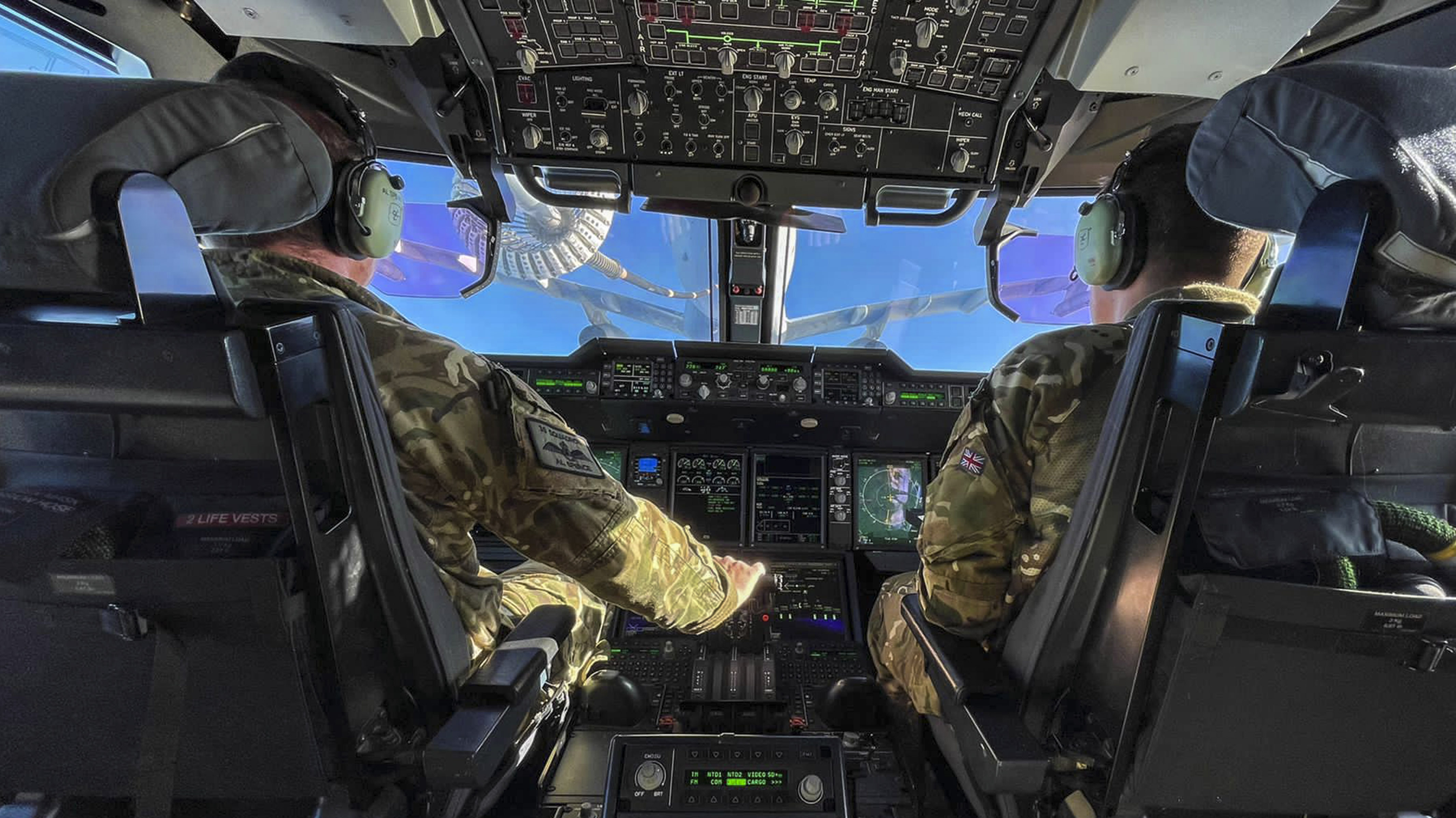 Image shows RAF pilots in transport aircraft cockpit.